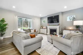 Great room/family room is light and bright!  Additional windows add to the charm and character of this room.  Please stop and admire the striking hickory hardwoods!
