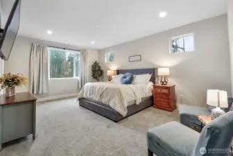 Primary suite is expansive and has room for a private seating area.