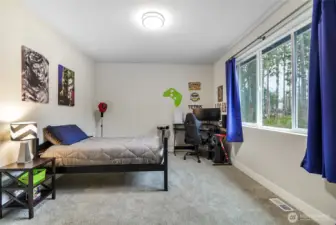 This bedroom is private and has a view of the backyard.