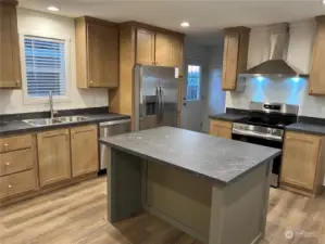 Another view of the kitchen. Note the pantry next to the refrigerator.