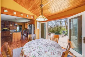 This spacious kitchen features a work desk, pantry, and a cozy eating area that leads out to the back paved patio—perfect for enjoying meals and outdoor living. Recent updates include granite countertops, new floors, and custom cabinetry, creating a functional and stylish space.