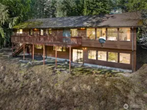The back of the house has a very large deck that runs from the living/dining area to the kitchen--perfect for all your outdoor entertaining, viewing, and relaxing needs.