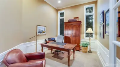 Main level den with lofted ceiling- an ideal work from home space!