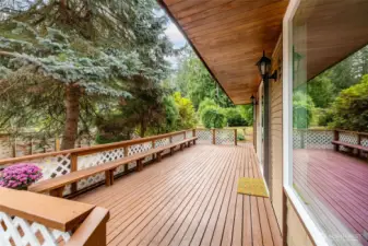 A large deck with built in seating on the east side of the house catches morning light.