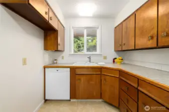 Ample cabinet space for storage and room for a butcherblock island on the left.