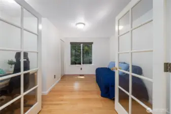 The first room down the hall is a combination office/guest room, or bedroom #1. Solid Oak wood floors.