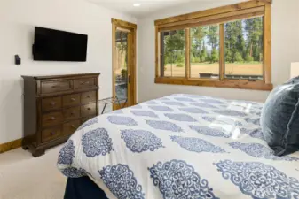 Primary bedroom with access to outdoor patio where hot tub is located