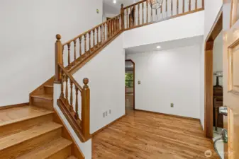 Entry - spindle staircase and gleaming hardwoods