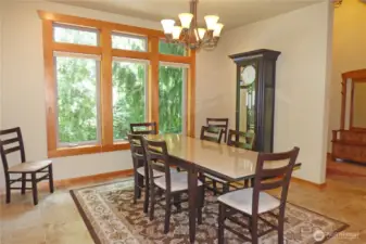 Large dining room with wood wrapped windows and grandfather clock (stays with home).