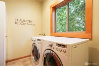 Laundry room with cabinet, sink, washer & dryer (stays with home). Nice window for fresh air.