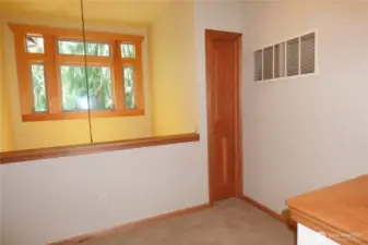 Landing at the top of the stairs overlooking the front door. Small closet for small items or small 'fort'.