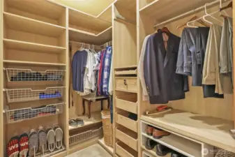 Primary closet #2 with built-in drawers and shelves.