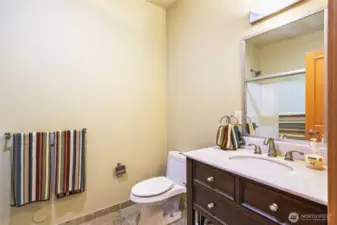 Downstairs, full bathroom with tiled floor.