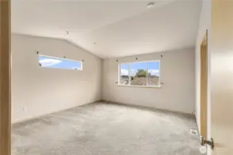 Huge Primary bedroom with vaulted ceilings,  ensuite and walk in closet.