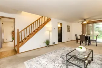 The living room faces the kitchen and stairway to bedrooms and extra bathrooms.