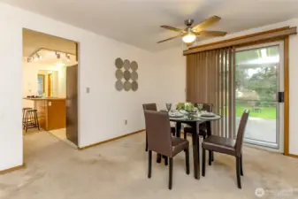 This view leads to the kitchen, half bath and laundry room beyond.