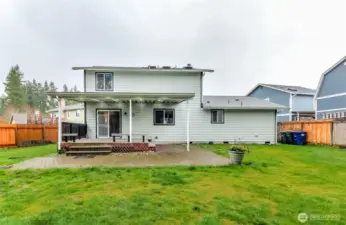 Straight on view of backyard and deck.