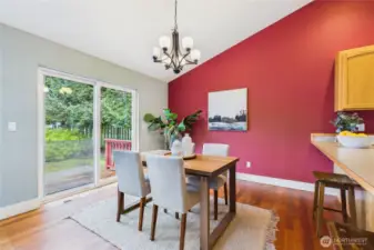 Lovely dining room with a slider out to a little deck and patio.