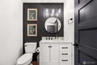 Stylish main floor powder room with beadboard accent wall.