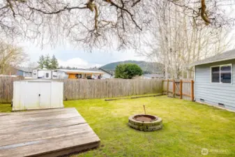 Back yard with deck, fire pit and shed