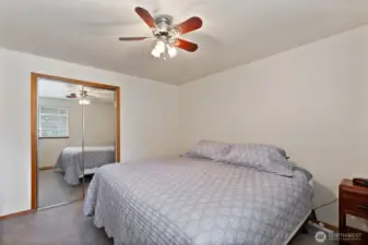 Another full mirrored closet and ceiling fan for comfort.