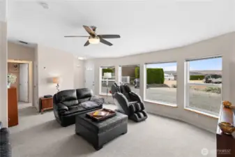 Living room with ceiling fan and fresh paint.
