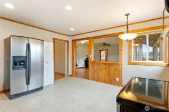 Open layout connects to living room with pass-through bar and large window for natural light