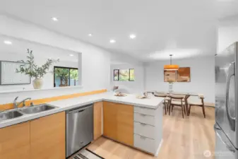 KITCHEN | The newly installed lighting makes this bright kitchen a beautiful space to work in. The flow to the dining room and family room provides the right amount of connection between areas.