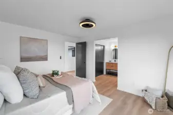 PRIMARY BEDROOM 2 | This angle shows the connection to the hallway as well as it's own bathroom. The closet is accessed throught the vanity area to the left.