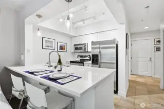 Bright kitchen with quartz countertops.