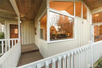 Covered front porch wraps to the fully fence side courtyard.