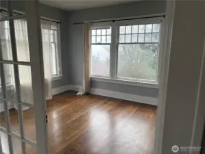 French doors separate generous upper unit living room and dining room/office/flex room.