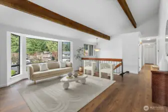 Wood fireplace & a large bay window with natural light.