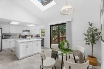 Bright kitchen with center Island, casual dining area, & skylight opens to the deck—perfect for gatherings!