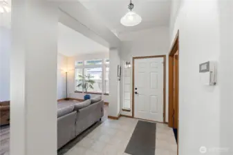 Welcoming entry foyer with high ceilings and natural light, flowing easily into the main living space.