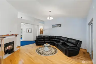Spacious family room with cozy fireplace and open flow connecting the main living areas.
