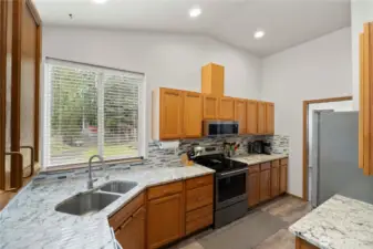 Well-appointed kitchen featuring Quartz countertops, stainless steel appliances, and abundant cabinet space.
