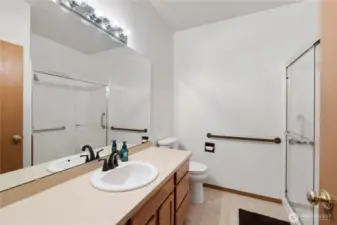 Spacious bathroom featuring a large vanity, walk-in shower with glass door, and clean, bright finishes.