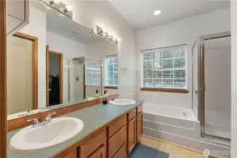 Primary bathroom with double vanity, soaking tub, and separate shower for everyday comfort.
