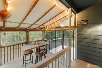 Covered outdoor entertaining area with ambient lighting, perfect for year-round relaxation.