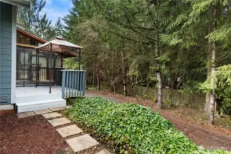 Private backyard setting with deck and gazebo, surrounded by mature trees for a peaceful outdoor retreat.