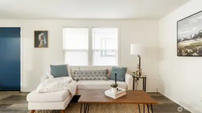 Living room has lots of Windows to bring in the light