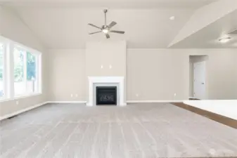 Open great room includes a cozy gas fireplace and ceiling fan for seasonal air circulation and temperature control.Photo from same plan on different lot, finishes and features will vary.