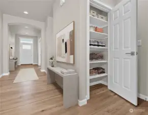 Entry hall provides premium wall space for your favorite art. The central location of the linen closet allows easy accessibility. Photo is virtually staged for reference only.