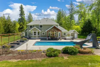 What an amazing space.  Covered outdoor living, in ground pool with slide, raised garden beds.  Just a beautiful space to enjoy.