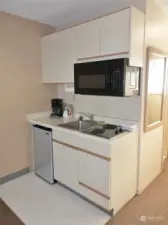 Kitchenette w/ mini-frig, microwave, sink, and a 2-burner stove top.