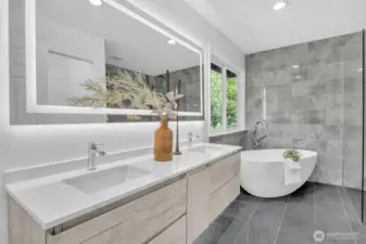 State-of-the-art remodel for this generously sized primary bath featuring a dual vanity, a stand-alone bathtub and an Italian shower.