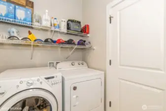 "Laundry room with built-in shelving and space for folding or storage."