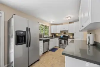 Bright, updated kitchen featuring newer cabinets, quartz countertops and modern finishes.