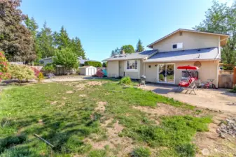 This is the back of the house.  Each side of the house has a gate to get to the front yard.  On the the narrow side of the house, there is a shed and a cement pad for the A.C.